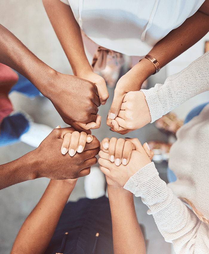 Support, prayer and trust with people holding hands in counseling for mental health, wellness or teamwork. Worship, hope and community group therapy for help, solidarity or spiritual faith from above